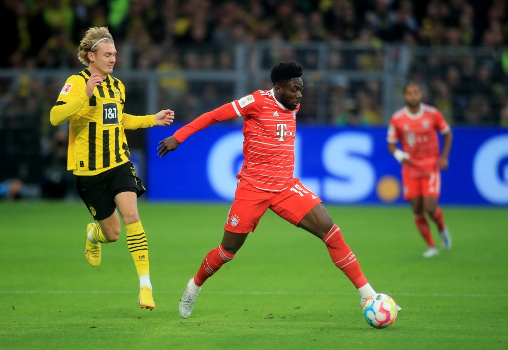 October 8, 2022 Bayern Munich's Alphonso Davies in action with Borussia Dortmund's Julian Brandt REUTERS/Leon Kuegeler