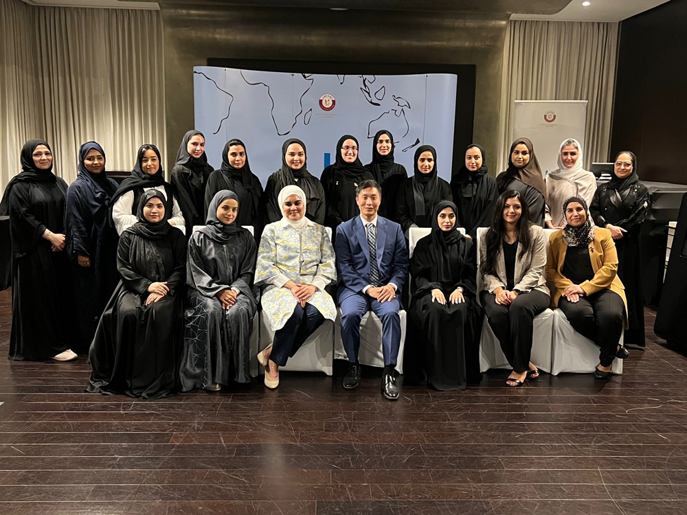 Zainab Al Suwaij with officials and participants during a workshop in Doha. 