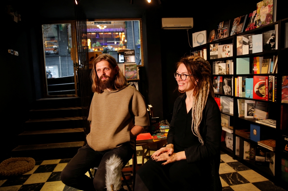A Russian couple, Oleg Chernousov and Aleksandra Chernousova, talks during an interview with Reuters at their newly opened bookstore in Istanbul, Turkey October 7, 2022. Reuters/Dilara Senkaya