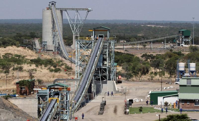 Employees walk under a concentrator at Ngezi platinum processing plant near Harare on November 28, 2013. File Photo / Reuters
