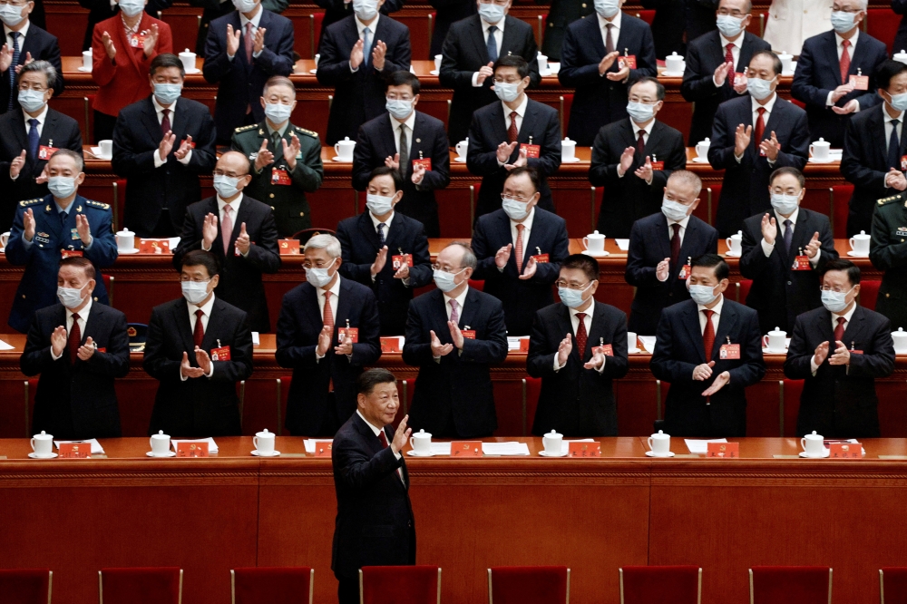 Chinese President Xi Jinping waves as he arrives for the opening ceremony of the 20th National Congress of the Communist Party of China, at the Great Hall of the People in Beijing, China October 16, 2022. Reuters/Thomas Peter 