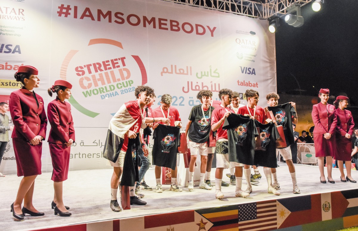 Qatar Airways cabin crew celebrating with a winning team.