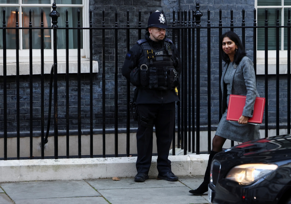 Britain's Secretary of State for the Home Department Suella Braverman walks outside Downing Street in London, Britain, on October 18, 2022. REUTERS/Henry Nicholls