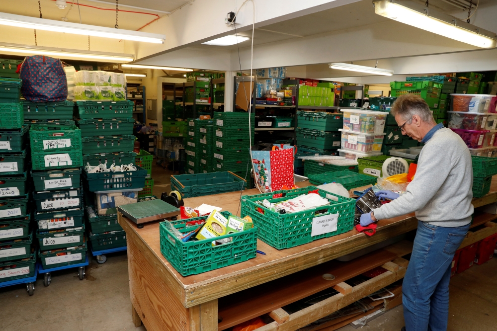 A man works at The DENS charity food bank, as the spread of the coronavirus disease (COVID-19) continues, in Hemel Hempstead, Britain, March 25, 2020. REUTERS/Paul Childs/File Photo
