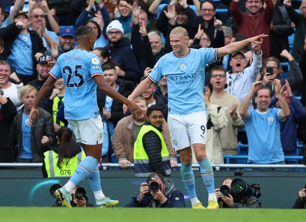 Manchester City's Erling Braut Haaland celebrates scoring their second goal against Brighton & Hove Albion with teammate Manuel Akanji at the Etihad Stadium in Manchester on October 22, 2022.  Action Images via Reuters/Molly Darlington