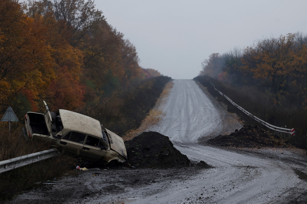 A destroyed car is seen on the main road, as Russia's invasion of Ukraine continues, in the eastern Donbas region of Bakhmut, Ukraine, October 30, 2022. Reuters/Clodagh Kilcoyne