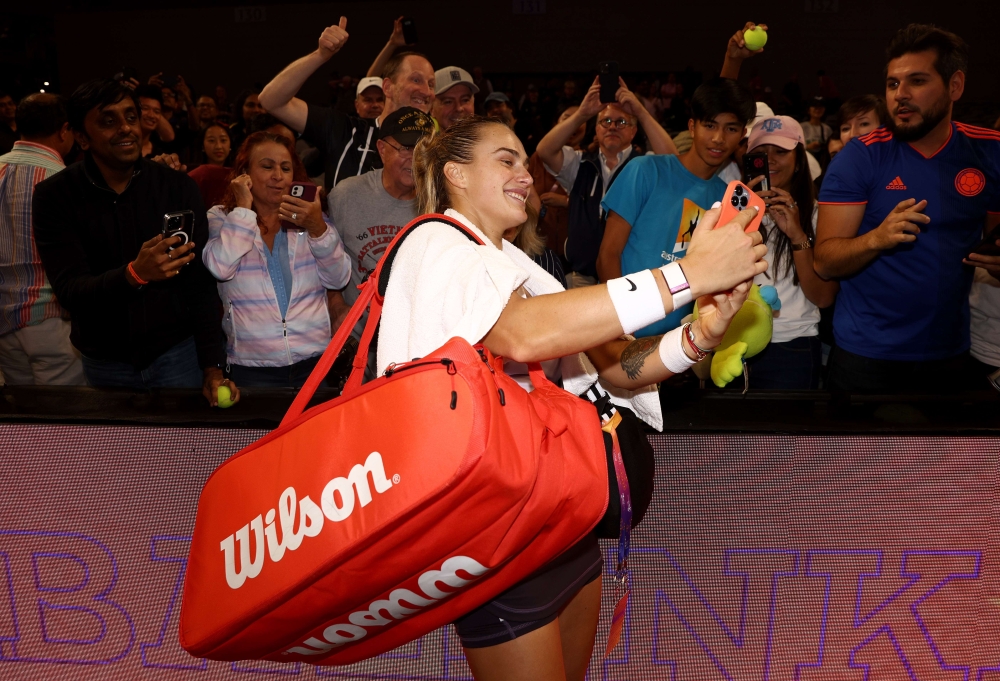 Aryna Sabalenka of Belarus takes selfies with after defeating Iga Swiatek of Poland in their Women's Singles Semifinal match during the 2022 WTA Finals, part of the Hologic WTA Tour, at Dickies Arena on November 06, 2022 in Fort Worth, Texas. Tom Pennington/Getty Images/AFP
