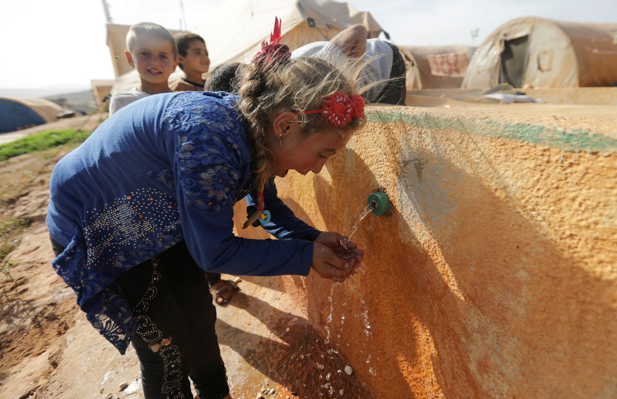 File Photo: An internally displaced Syrian girl drinks water at Teh camp in northern Idlib, Syria, on May 5, 2021. (REUTERS/Khalil Ashawi)

