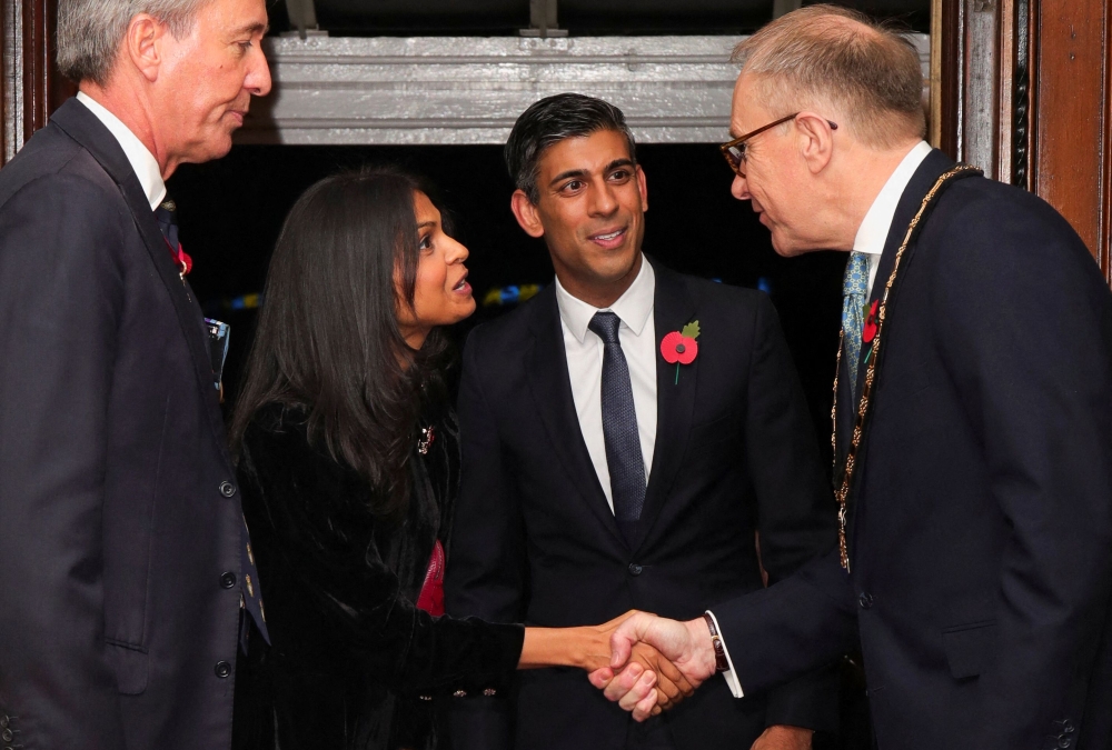 Britain's Prime Minister Rishi Sunak (second right) and his wife Akshata Murthy (second left) arrive to attend the annual Royal British Legion Festival of Remembrance at the Royal Albert Hall in London on November 12, 2022. (Photo by CHRIS RADBURN / POOL / AFP)