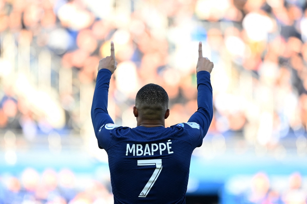 Paris Saint-Germain's French forward Kylian Mbappe celebrates after scoring his team's first goal during the French L1 football match between Paris Saint-Germain FC and AJ Auxerre at the Parc des Princes stadium in Paris on November 13, 2022. (AFP/Franck Fife)