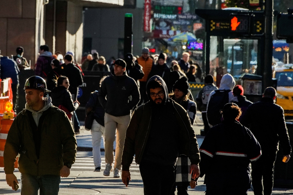 People walk on the New York City street of 9th Avenue in Manhattan as according to a United Nations report, the world's population is estimated to reach 8 billion by November 15 of this year, in New York, U.S., November 14, 2022. Reuters/Eduardo Munoz