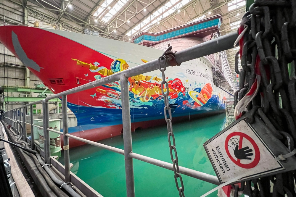 (Files) In this file photo taken on January 26, 2022, the 342m long and almost finished cruise ship “Global Dream“ is pictured in the main assembly hall of the shipbuilder 