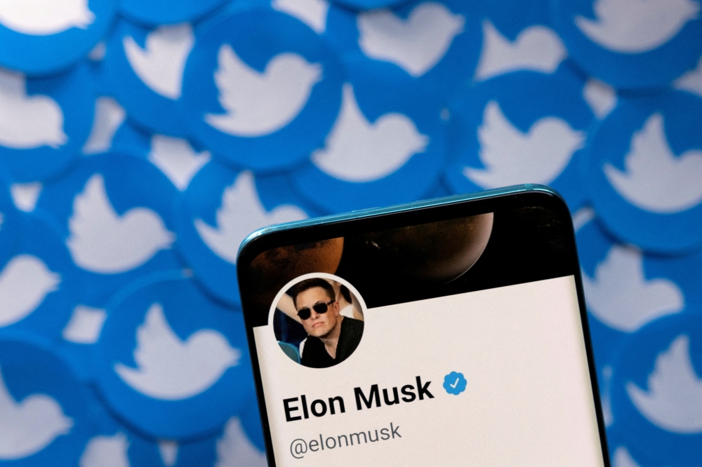 Elon Musk's Twitter profile is seen on a smartphone placed on printed Twitter logos in this picture illustration taken on April 28, 2022. File Photo / Reuters