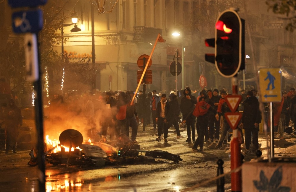 General view of people clashing with the police in Brussels, after the World Cup match between Belgium and Morocco on Sunday. (REUTERS/Yves Herman)