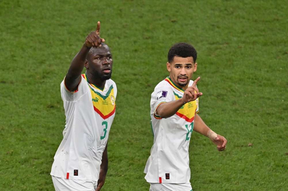 Senegal's defender Kalidou Koulibaly celebrates wit teammateIliman Ndiaye after scoring his team's second goal during the Qatar 2022 World Cup Group A match against Ecuador at the Khalifa International Stadium in Doha on November 29, 2022. (Photo by JUNG Yeon-je / AFP)