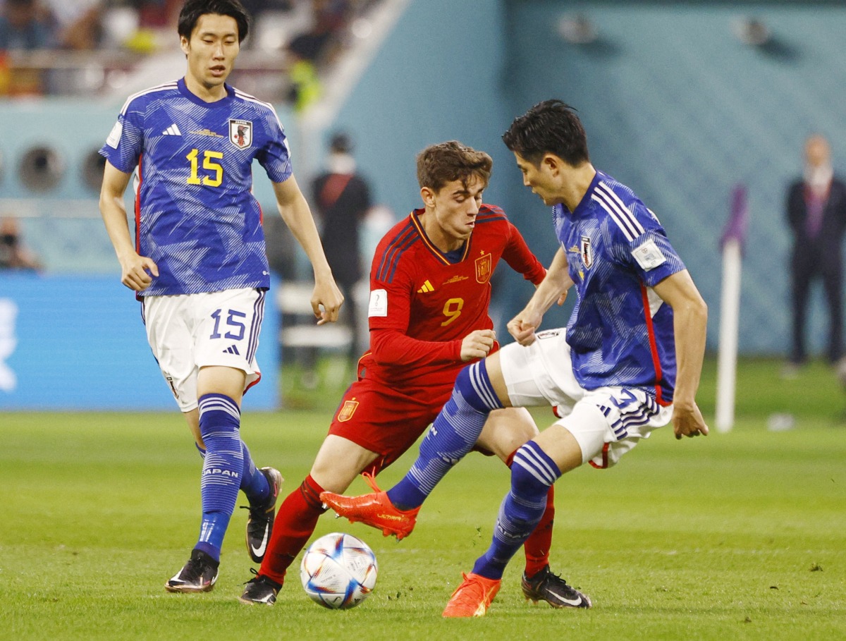 Japan’s Shogo Taniguchi in action with Spain’s Gavi