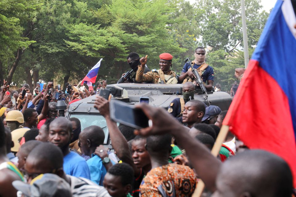 Burkina Faso's self-declared new leader Ibrahim Traore is welcomed by supporters holding Russian's flags as he arrives at the national television standing in an armoured vehicle in Ouagadougou, Burkina Faso, on October 2, 2022. File Photo / Reuters
