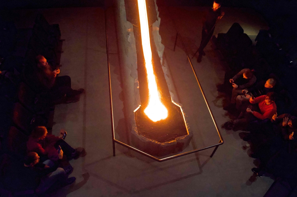 Real molten lava originated from tephra and that erupted in 1918 from the Katla Volcano in southern Iceland, cools down on the basalt structure at the Lava Show showroom in Reykjavik city center, Iceland, on December 1, 2022. (Photo by Jeremie RICHARD / AFP)