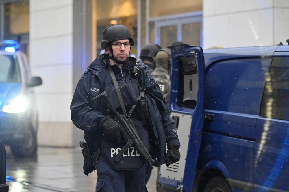 Police officers secure the area at a Christmas market in Dresden, Germany, December 10, 2022. Reuters/Matthias Rietschel
