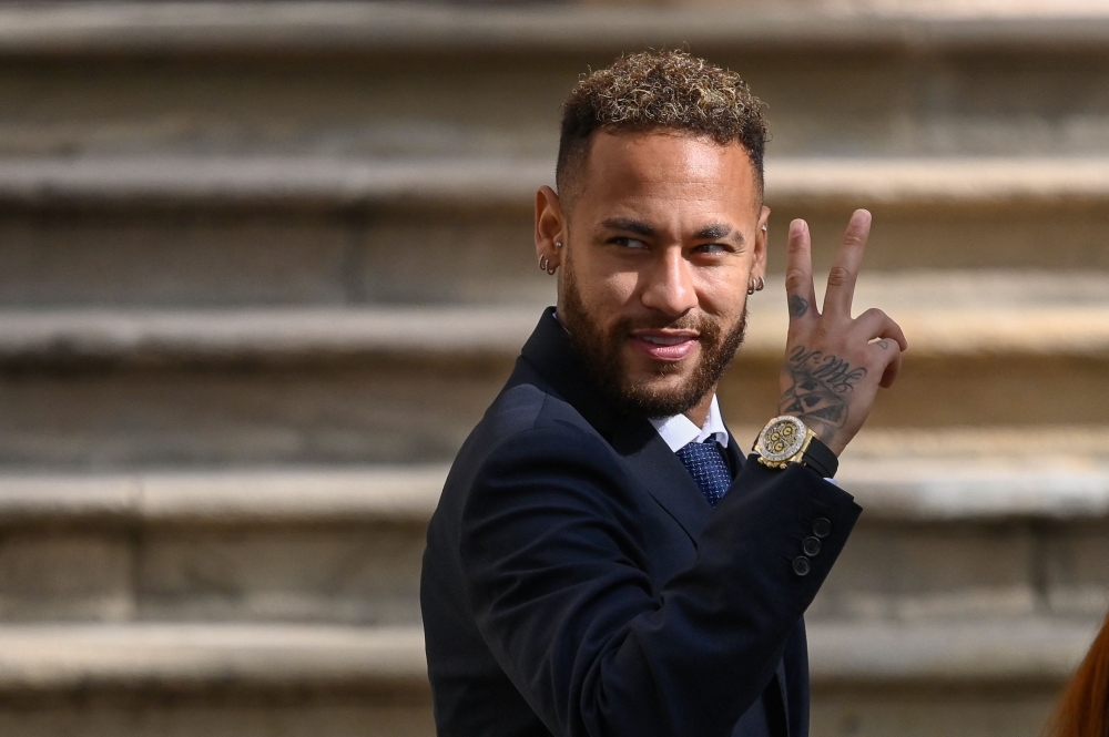 In this file photo taken on October 18, 2022, Paris Saint-Germain's Brazilian forward Neymar gestures as he leaves after attending a hearing at the courthouse in Barcelona, on the second day of his trial. (Photo by Josep Lago / AFP)