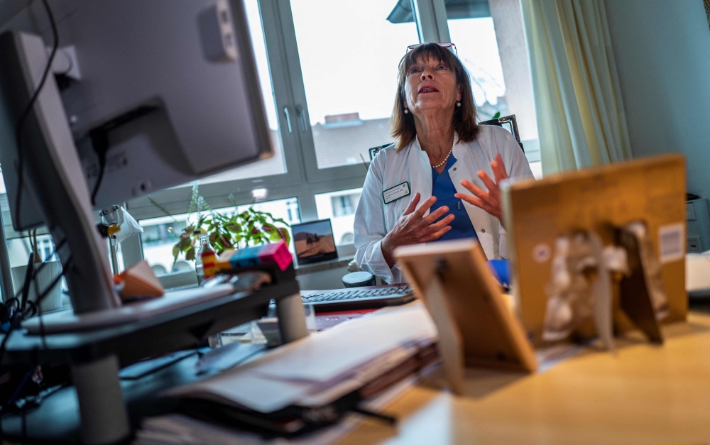Director of the pediatric ward of Berlin's Saint Joseph Hospital Beatrix Schmidt speaks during an AFP interview at her desk on December 13, 2022. Photo by John MacDougall / AFP