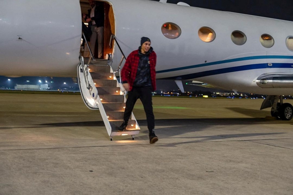 US basketball star Brittney Griner steps off a plane following her release from prison in Russia, in an unknown location, in this picture obtained from social media released on December 16, 2022. (US Army South/Miguel A. Negron via REUTERS) 