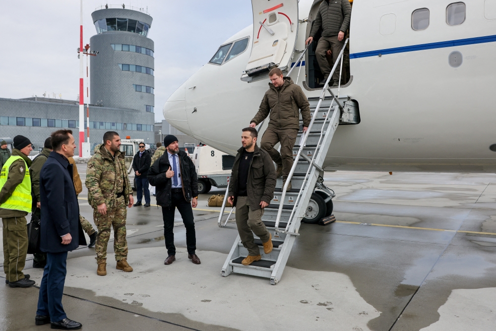 Ukrainian President Volodymyr Zelensky leaves a plane to meet with Polish President Andrzej Duda (not pictured) after Zelensky's visit to Washington, at Rzeszow-Jasionka Airport, Poland, on December 22, 2022. Jakub Szymczuk/KPRP/Handout via REUTERS