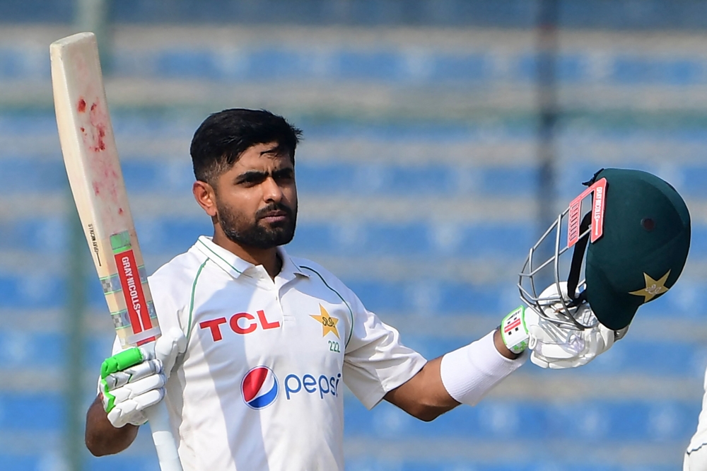 Pakistan's captain Babar Azam gestures after scoring a century (100 runs) during the first day of the first cricket Test match between Pakistan and New Zealand at the National Stadium in Karachi on December 26, 2022. (Photo by Asif Hassan / AFP)