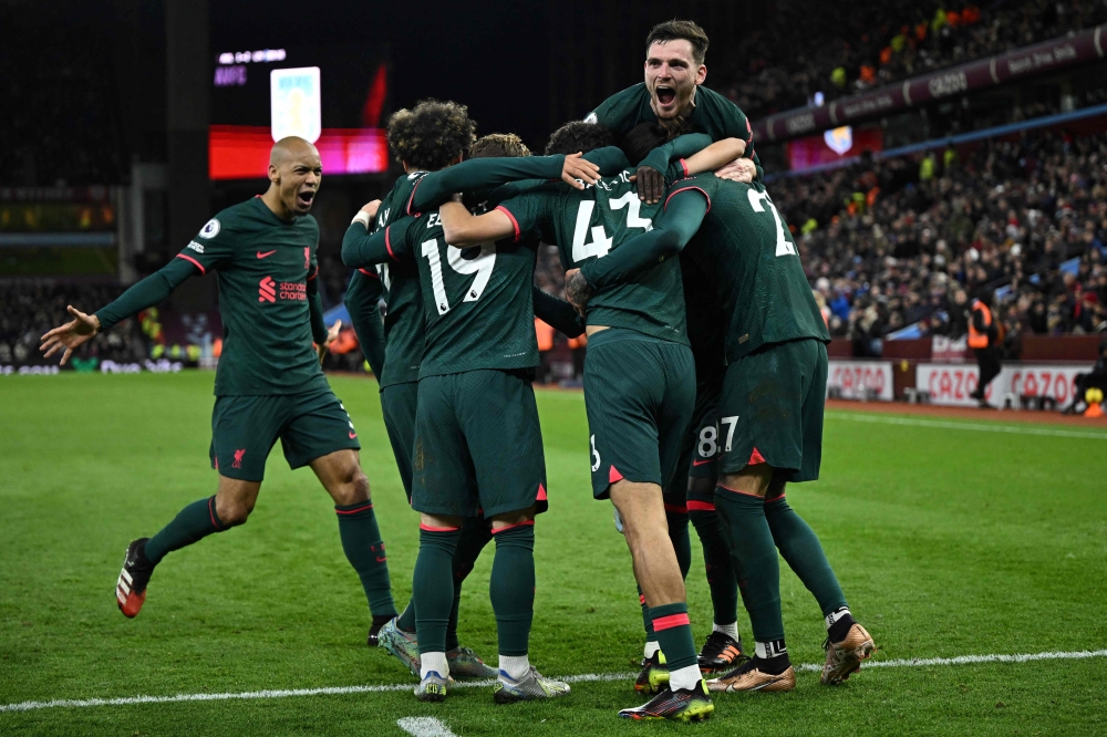 Liverpool's Spanish defender Stefan Bajcetic celebrates with teammates after scoring his team third goal during the English Premier League football match between Aston Villa and Liverpool at Villa Park in Birmingham, central England on December 26, 2022. (Photo by Oli SCARFF / AFP)