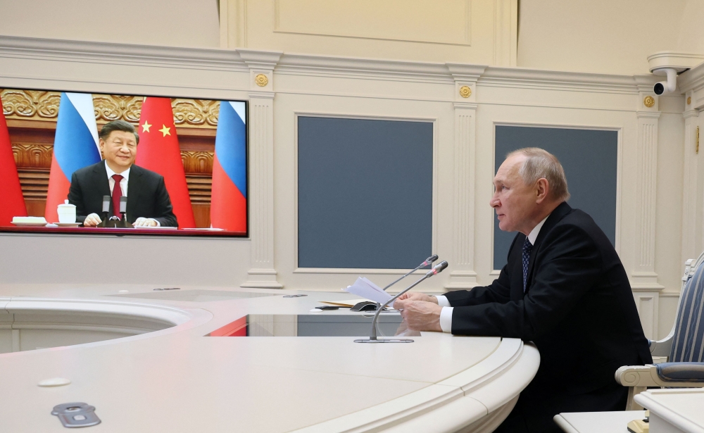 Russian President Vladimir Putin holds a meeting with Chinese President Xi Jinping via a video link at the Kremlin in Moscow on December 30, 2022. (Photo by Mikhail Klimentyev / SPUTNIK / AFP)
