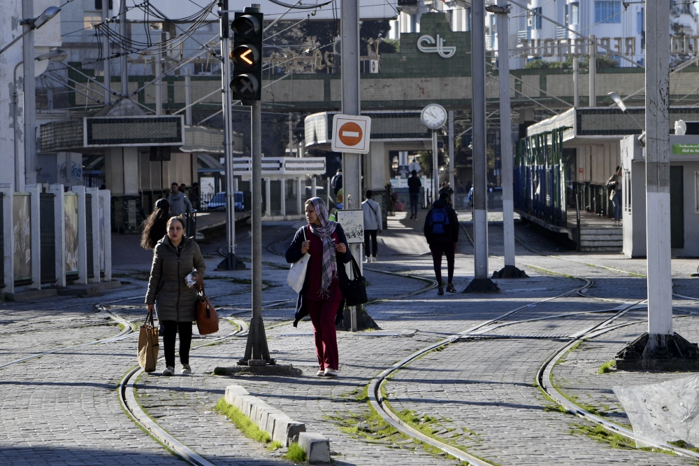 Tunisians are pictured next to a tram station in the capital Tunis' Ariana district, on January 2, 2023, after a strike by the public transport employees was announced the night before. (Photo by FETHI BELAID / AFP)