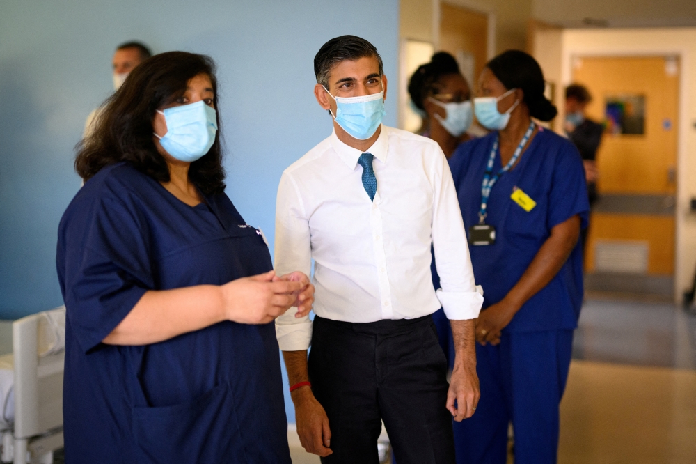 British Prime Minister Rishi Sunak speaks with members of staff as he visits Croydon University Hospital on October 28, 2022 in London, Britain. Leon Neal/Pool via REUTERS/File Photo