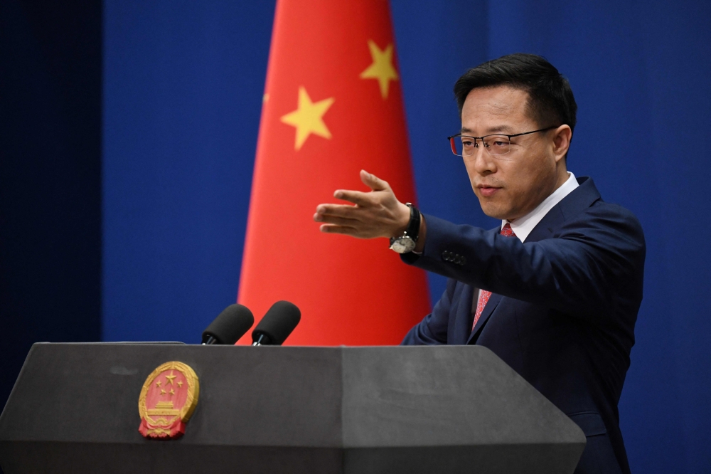 This file photo taken on April 8, 2020 shows Chinese Foreign Ministry spokesman Zhao Lijian taking a question at the daily media briefing in Beijing.  (Photo by Greg Baker / AFP)