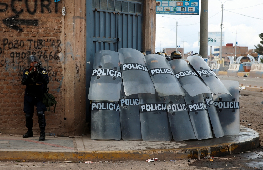 Peruvian police officers operate as demonstrators hold a protest demanding early elections and the release of Peruvian ousted leader Pedro Castillo, in Juliaca, Peru, January 8, 2023. (REUTERS/Hugo Courotto) 