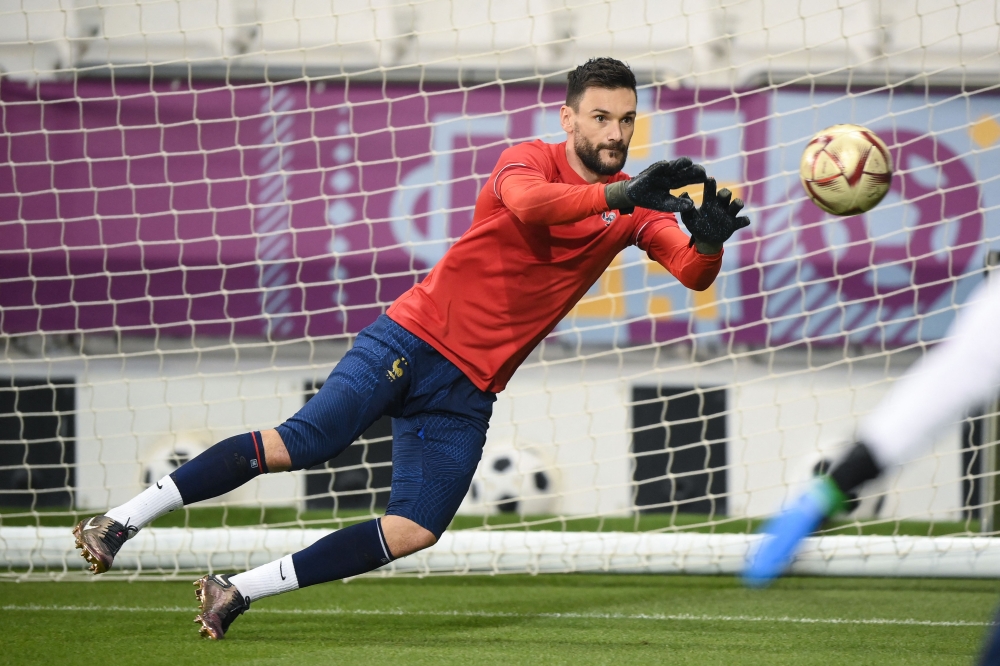 In this file photo taken on December 17, 2022 France's goalkeeper Hugo Lloris catches a ball during a training session at the Al Sadd SC training centre in Doha on the eve of the Qatar 2022 World Cup football final match between Argentina and France. (Photo by FRANCK FIFE / AFP)