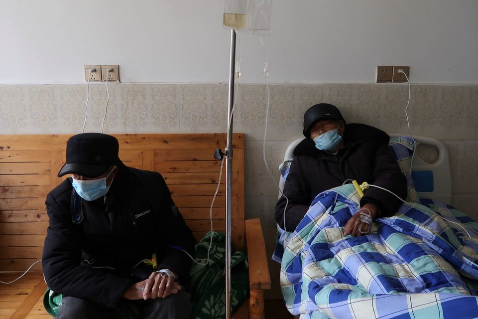 Tang Shunping, 80, receives IV drip treatment at a clinic in a village of Lezhi county after strict measures to curb the coronavirus disease (COVID-19) were removed nationwide, in Ziyang, Sichuan province, China December 29, 2022. REUTERS/Tingshu Wang
