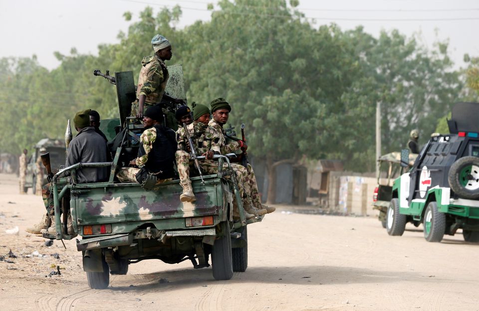 Nigerian military ride on their truck as they secure the area where a man was killed by suspected militants during an attack around Polo area of Maiduguri, Nigeria, on February 16, 2019. File Photo / Reuters
