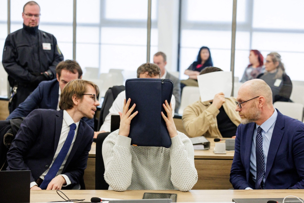 Defendant Rabieh R (background, right) and defendant Abdul Majed R (foreground, centre) sit next to their lawyers in the courtroom of the Higher Regional Court in Dresden, eastern Germany on January 10, 2023 prior to a hearing in the trial over a jewellery heist on the Green Vault (Gruenes Gewoelbe) museum in Dresden's Royal Palace in November 2019.  (Photo by JENS SCHLUETER / POOL / AF