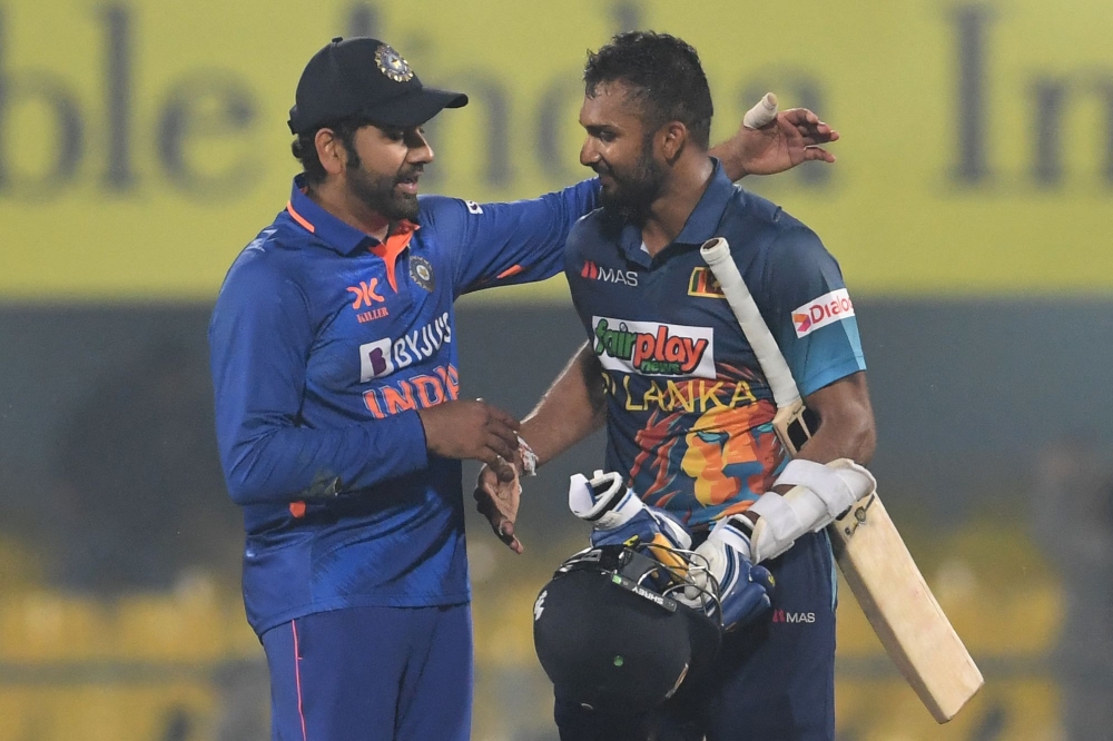 India's captain Rohit Sharma (left) congratulates Sri Lanka's captain Dasun Shanaka for his century (100 runs) at the end of the first one-day international (ODI) cricket match between India and Sri Lanka at the Assam Cricket Association Stadium in Guwahati on January 10, 2023. (Photo by Dibyangshu SARKAR / AFP)