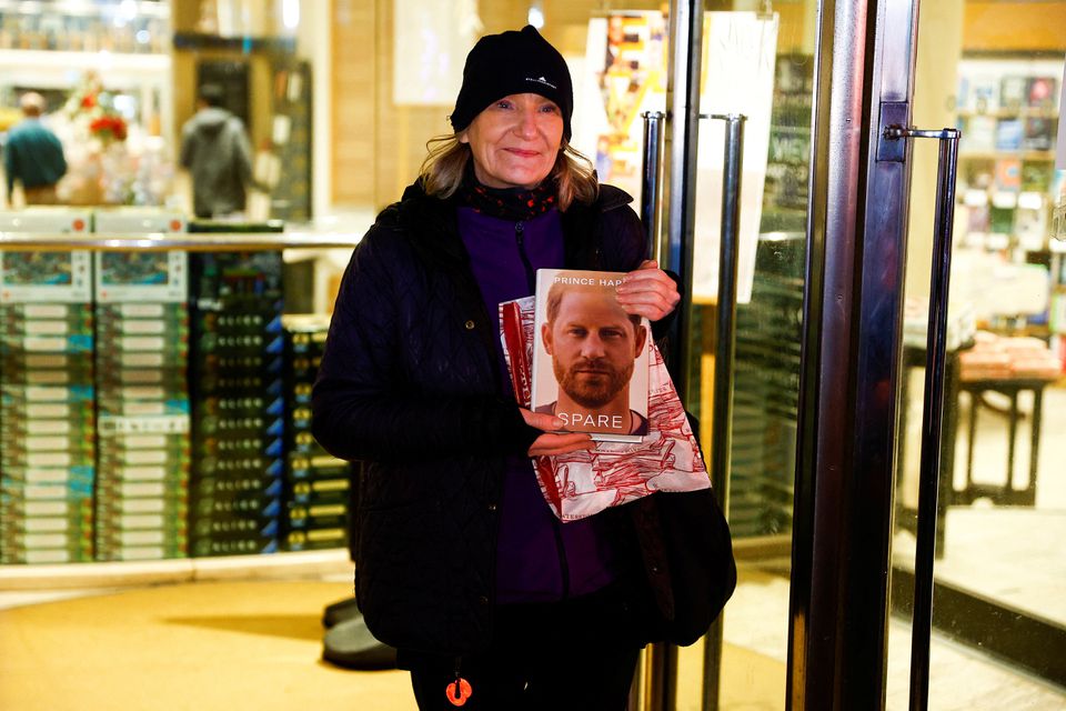 Caroline Lennon, the first person to purchase the copy of Britain's Prince Harry's autobiography 'Spare' from Waterstones bookstore, poses next to the store, in London, Britain on January 10, 2023. REUTERS/Peter Nicholls,
