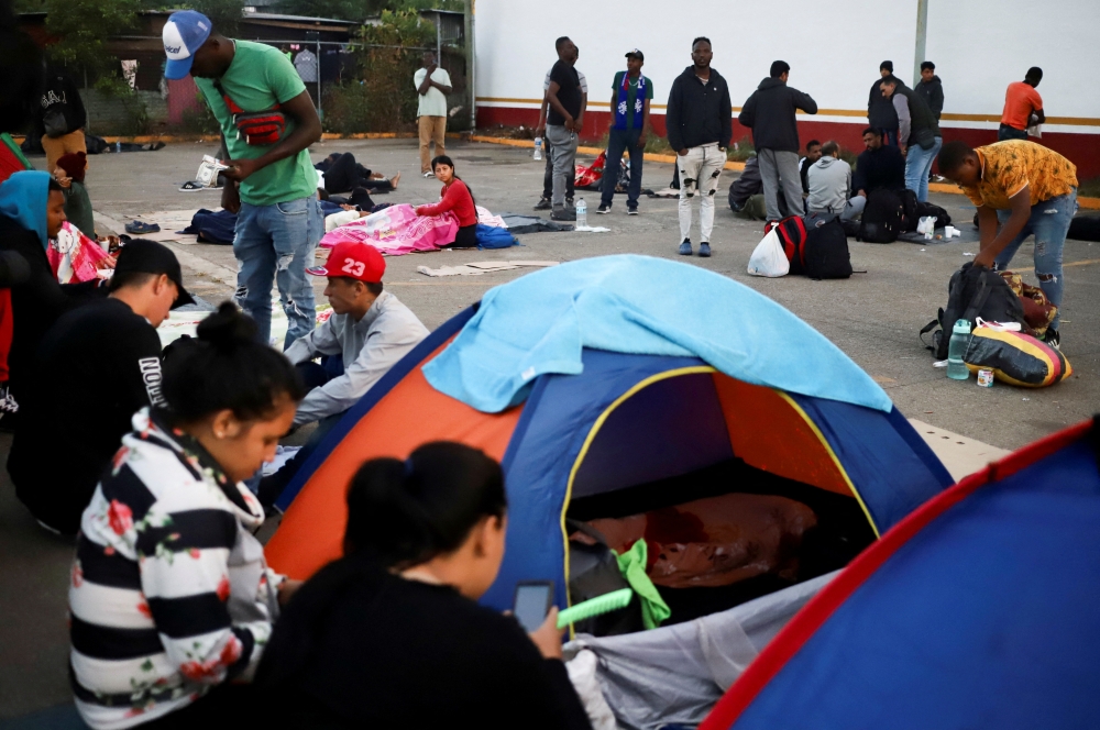 Migrants rest outside the Siglo XXI migrant detention center as they seek humanitarian visas to cross the country and reach the US, in Tapachula, Chiapas state, Mexico, on January 11, 2023. REUTERS/Jacob Garcia