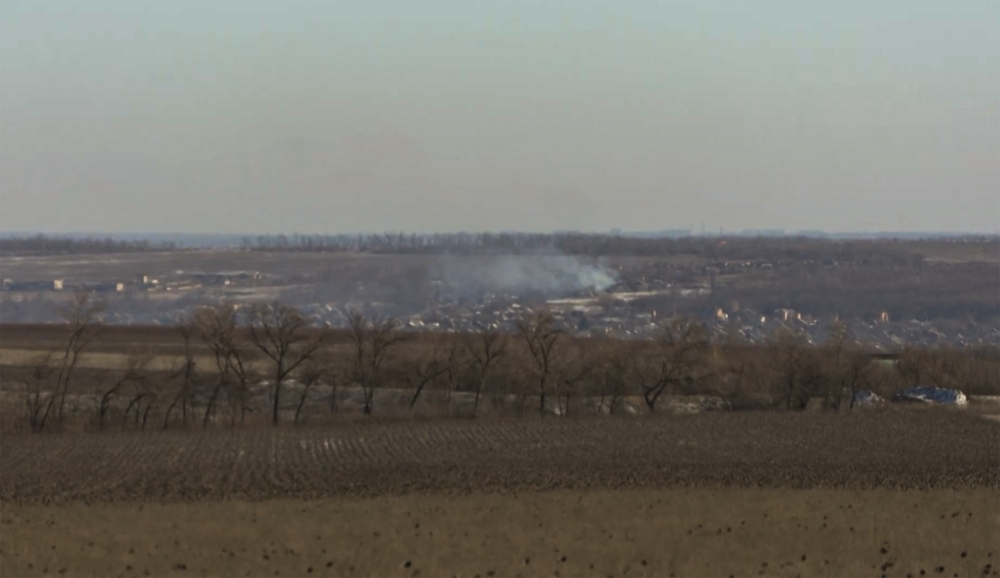 This grab taken from AFP video footage shows smoke rising, as seen from the outskirts of Soledar, eastern Ukraine on January 11, 2023. Photo by Arman SOLDIN / AFP