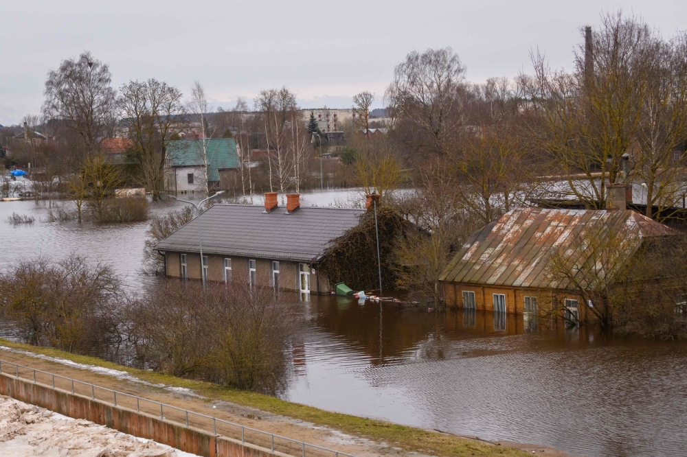 Flooded houses are pictured in Jekabpils, Latvia, on January 15, 2023. (Photo by Gints Ivuskans / AFP)