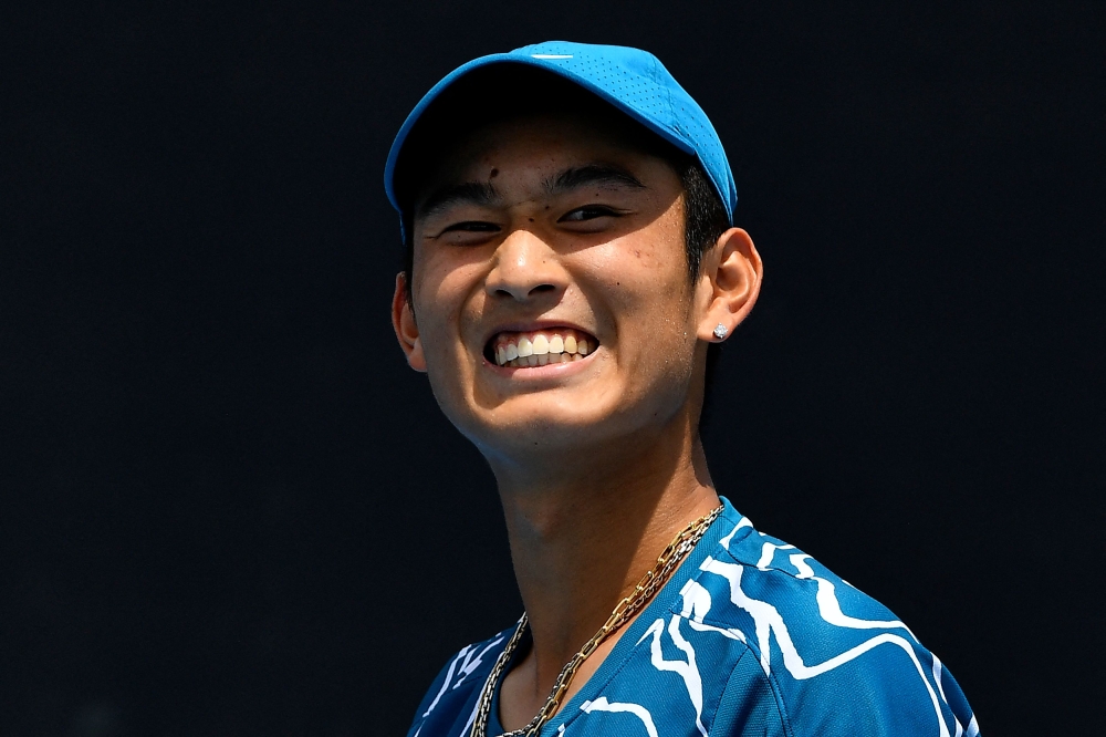 China's Shang Juncheng reacts on a point against Germany's Oscar Otte during their men's singles match on day one of the Australian Open tennis tournament in Melbourne on January 16, 2023. (Photo by Paul CROCK / AFP)