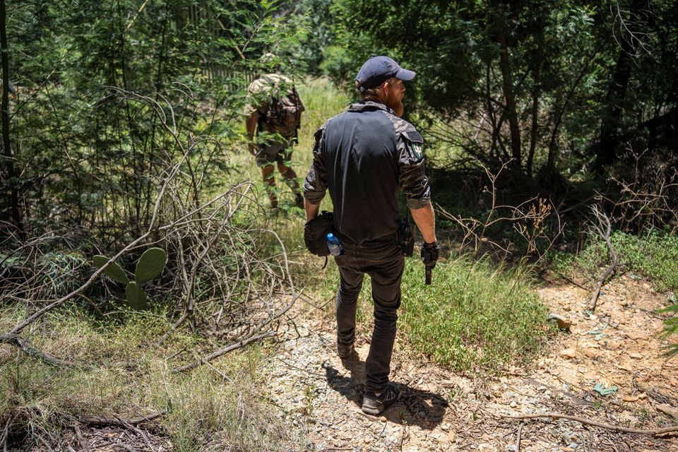 Members of a local community policing forum search the nearby bushes for Sheba, an eight-year-old tiger that escaped from a nearby farm in the Walkerville area on the outskirts of Johannesburg, South Africa on January 16, 2023 REUTERS/Ihsaan Haffejee
