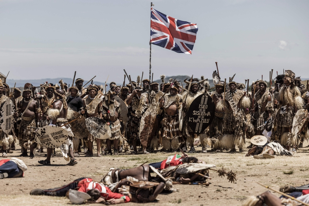 Amabutho Zulu regiments hold a British flag captured during the reenactment of the Battle of Isandlwana, in Isandlwana on January 21, 2023. The battle, fought on January 22, 1879 was the first major encounter in the Anglo-Zulu War between the British Empire and the Zulu Kingdom. (Photo by MARCO LONGARI / AFP)