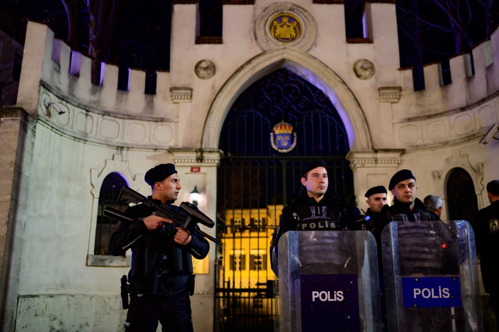 Riot police officers secure the entrance to the Consulate General of Sweden during a demonstration near the Turkish Embassy in Stockholm, in Istanbul, on January 21, 2023. (Photo by Yasin Akgul/ AFP)