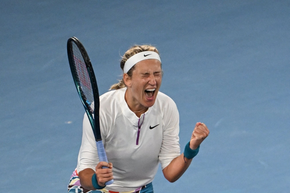 Belarus' Victoria Azarenka celebrates after victory against China's Zhu Lin during their women's singles match on day seven of the Australian Open tennis tournament in Melbourne on January 22, 2023. (Photo by Paul CROCK / AFP)