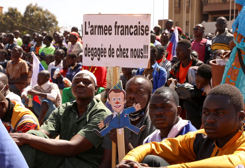 FILE PHOTO: People hold a sign as they gather to show their support to burkina Faso's new military leader Ibrahim Traore and demand the departure of the French ambassador at the Place de la Nation in Ouagadougou, burkina Faso January 20, 2023. The sign reads : 