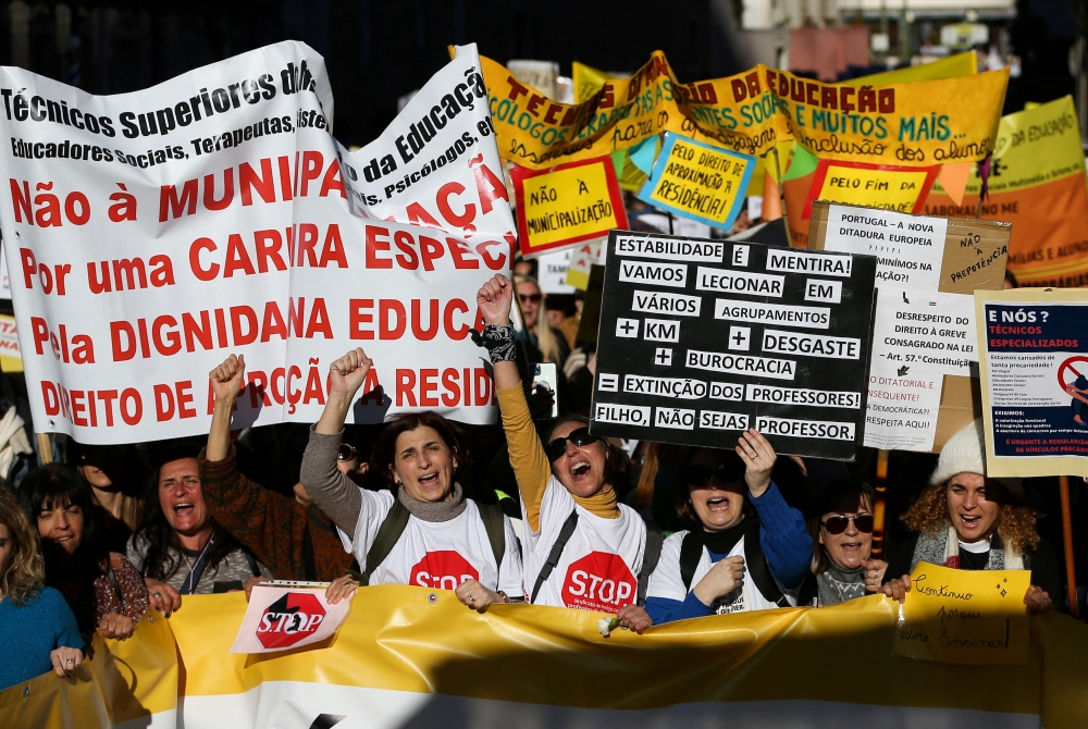People carry banners, as school workers demonstrate for better salaries and working conditions, in Lisbon, Portugal on January 28, 2023. REUTERS/Rodrigo Antunes
